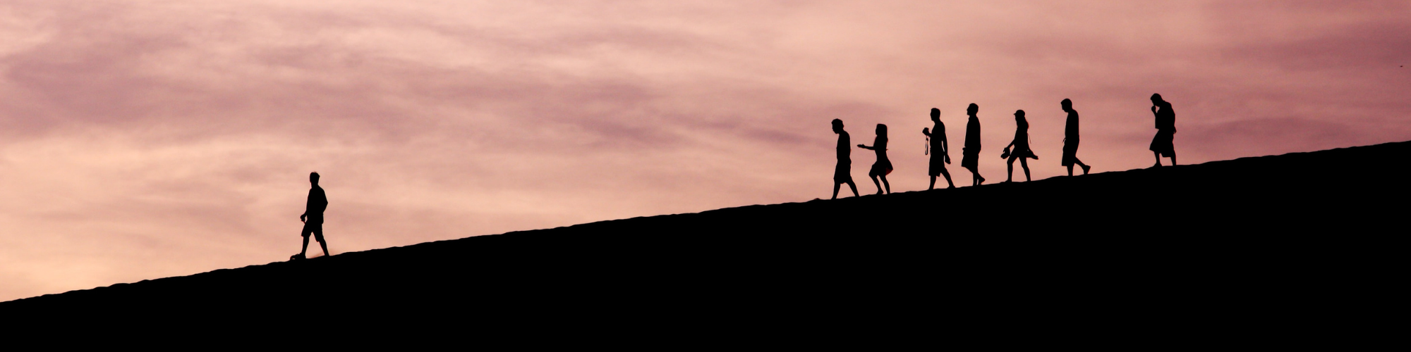 Blog banner 2000x500pxls Silouette image with people following one person up ahead