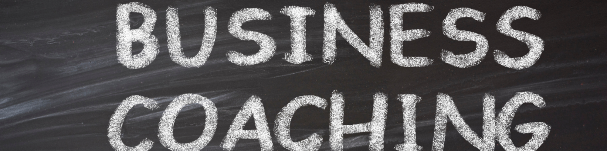 2000x500pxls The words business coaching written in chalk on a blackboard
