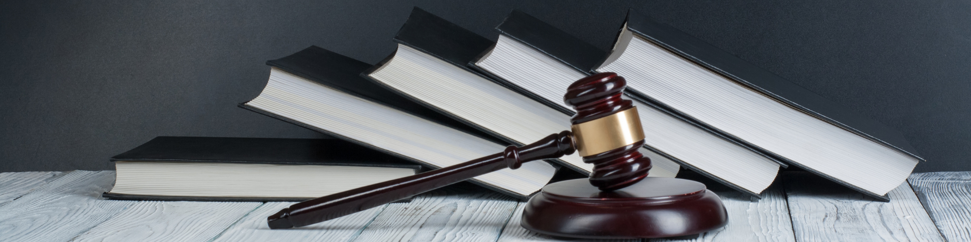 A row of books and a judge's gavel to understand the rules of the game